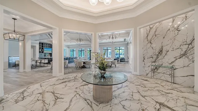 a living room with lots of furniture and a chandelier