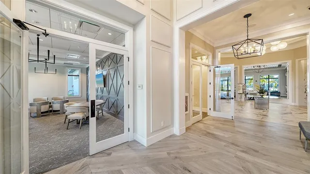 a living room with furniture and large windows