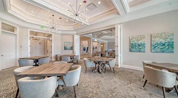 a living room with couch a flat screen tv and a large window