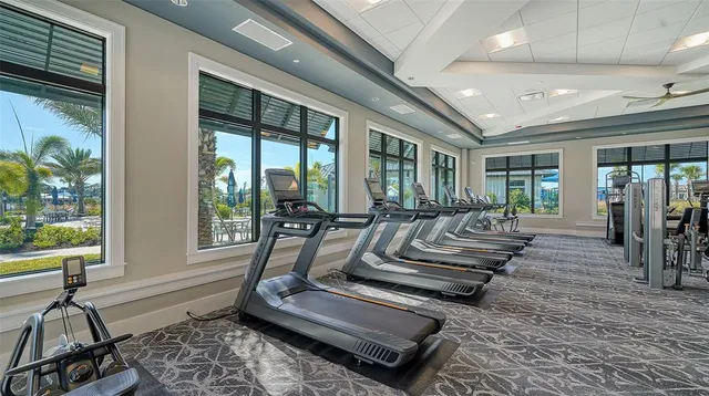 a view of a swimming pool with a table and chairs under an umbrella