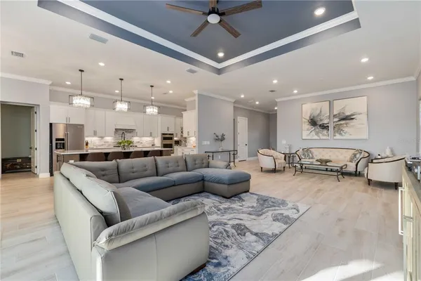 a living room with furniture and kitchen view