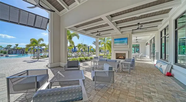 a view of a patio with a table and chairs under an umbrella