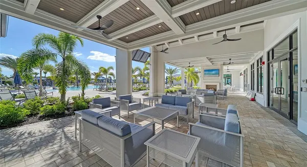 a view of a house with a yard and potted plants