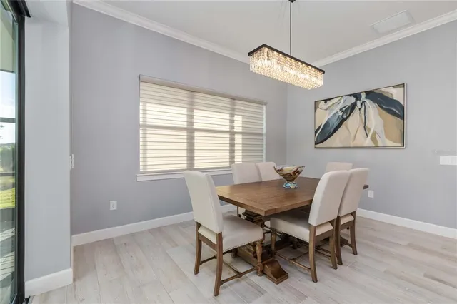 a view of a dining room with furniture wooden floor and a chandelier