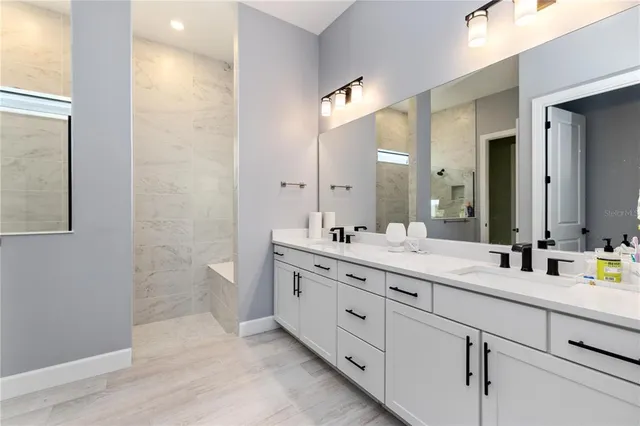 a bathroom with a double vanity sink mirror and double