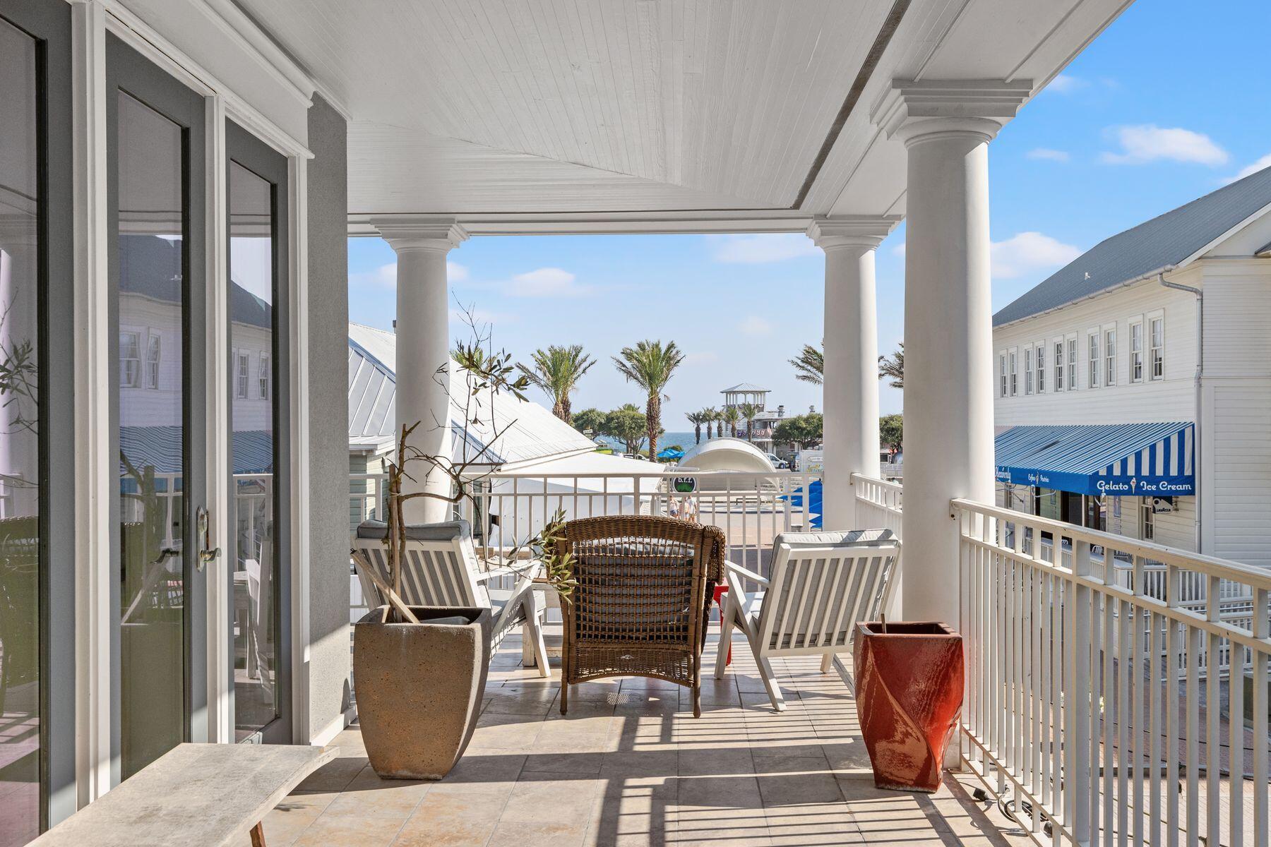 a living room with furniture a rug and a floor to ceiling window