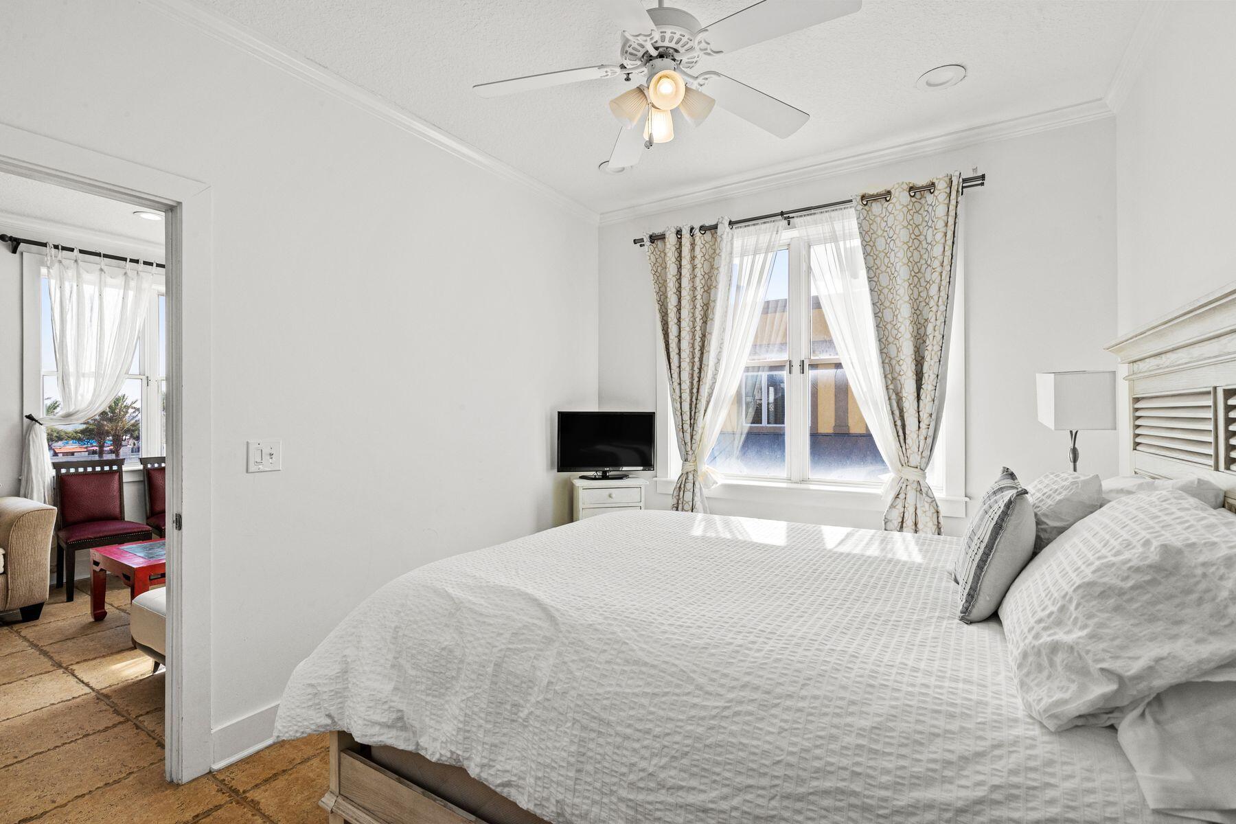 120 Quincy Circle Santa Rosa Beach, FL 32459 - Photo 11 of 26 a bedroom with a bed and a chandelier