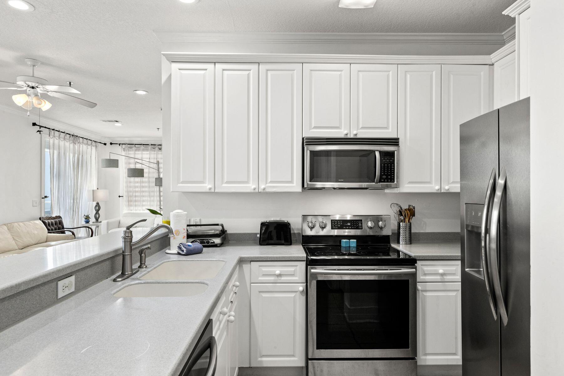 120 Quincy Circle Santa Rosa Beach, FL 32459 - Photo 16 of 26 a kitchen with stainless steel appliances a stove a sink and a refrigerator