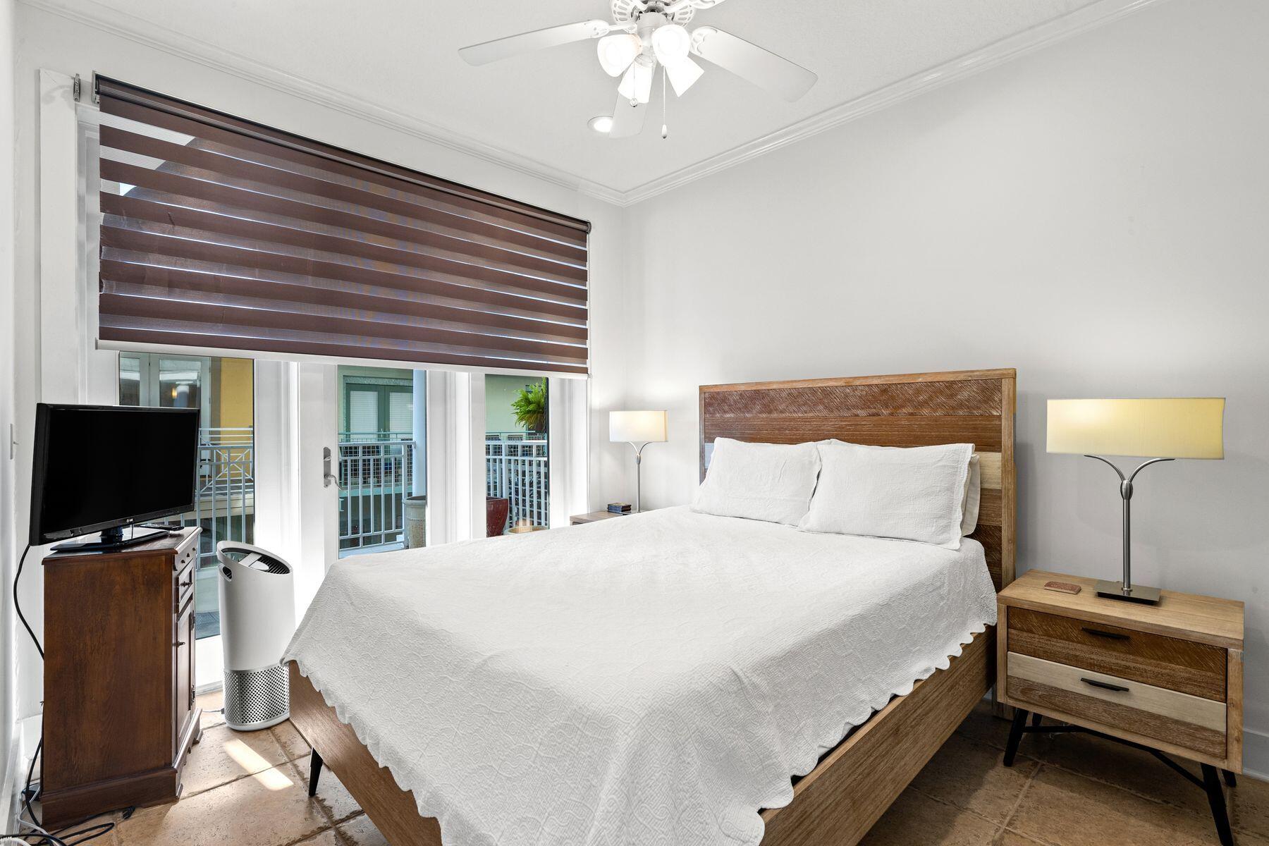 120 Quincy Circle Santa Rosa Beach, FL 32459 - Photo 22 of 26 a bedroom with a bed and a flat tv screen on dresser