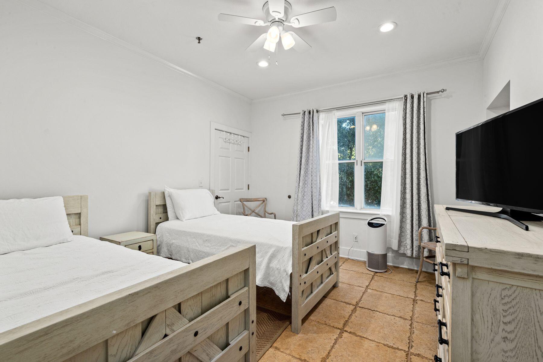 120 Quincy Circle Santa Rosa Beach, FL 32459 - Photo 23 of 26 a room with two bed and a flat screen tv