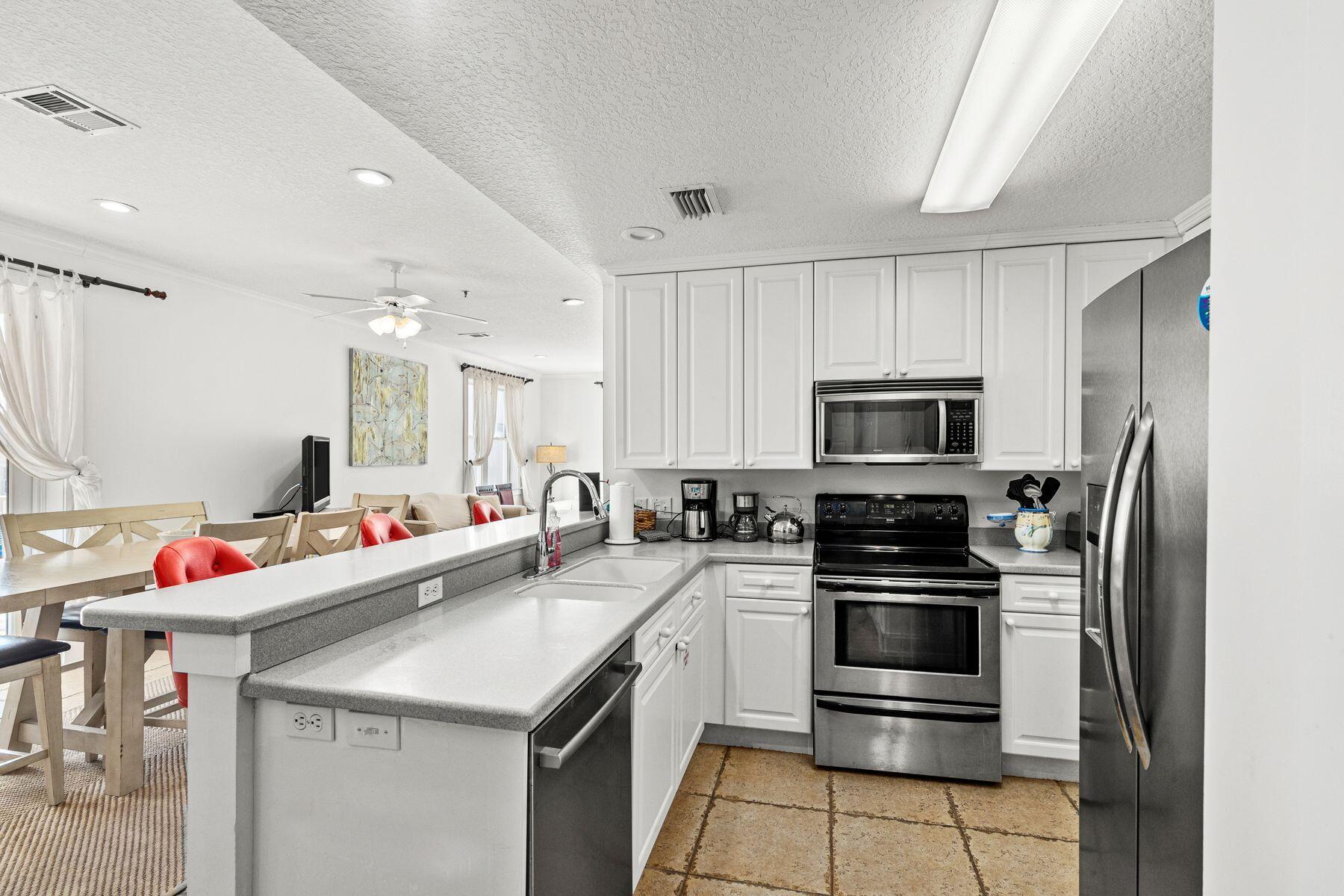 120 Quincy Circle Santa Rosa Beach, FL 32459 - Photo 8 of 26 a kitchen that has a sink and stainless steel appliances