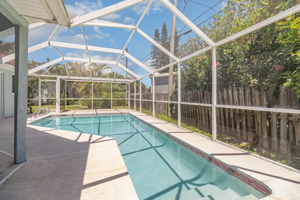 a view of a balcony with a floor to ceiling windows and wooden deck