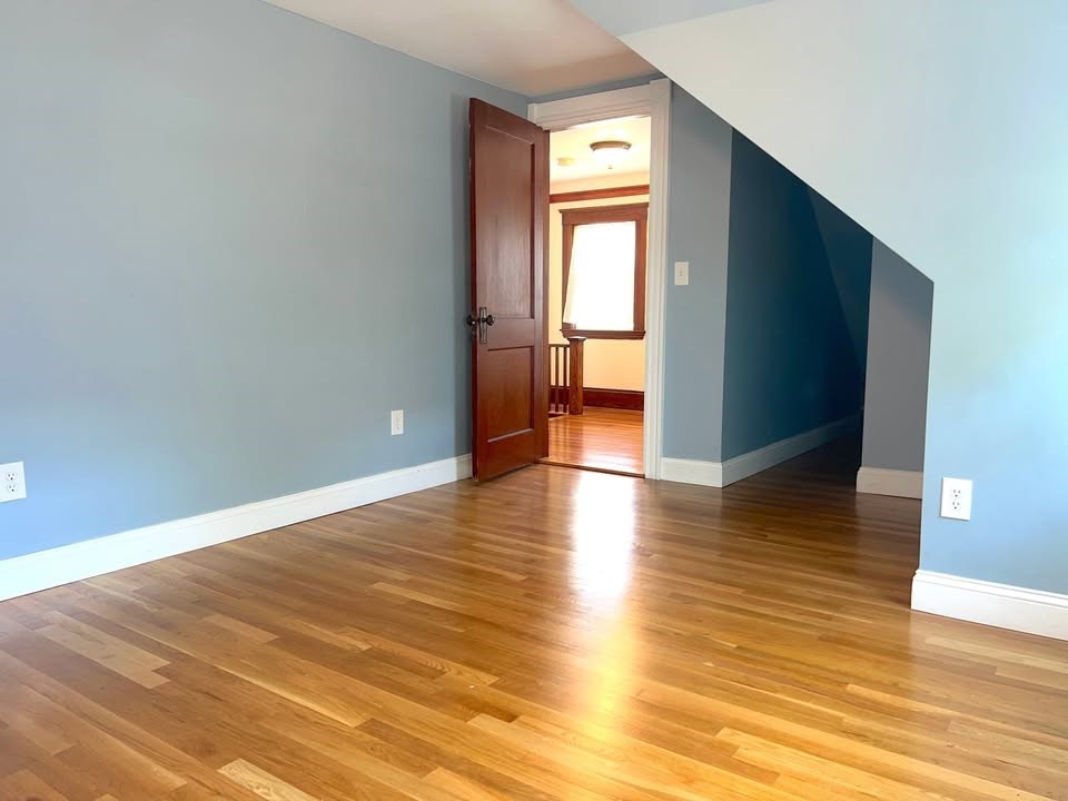 29 Richie Road, Unit 2 Quincy, MA 02169 - Photo 20 of 30 a view of empty room with wooden floor and fan