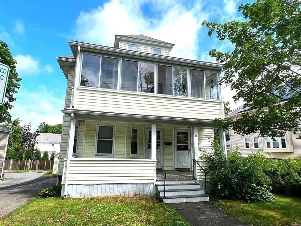 29 Richie Road, Unit 2 Quincy, MA 02169 - Photo 30 of 30 a view of white house with a yard and large tree