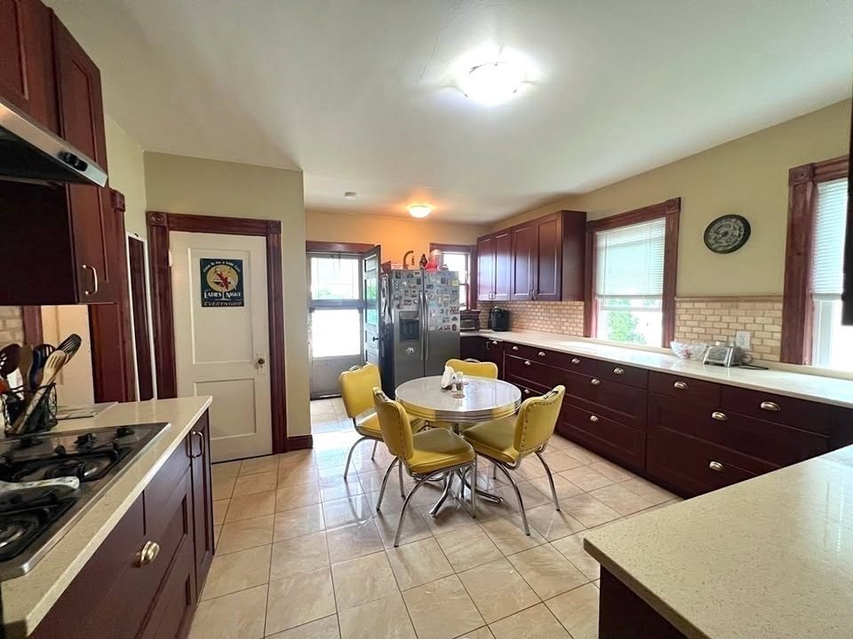 29 Richie Road, Unit 2 Quincy, MA 02169 - Photo 4 of 30 a kitchen with a table and chairs in it