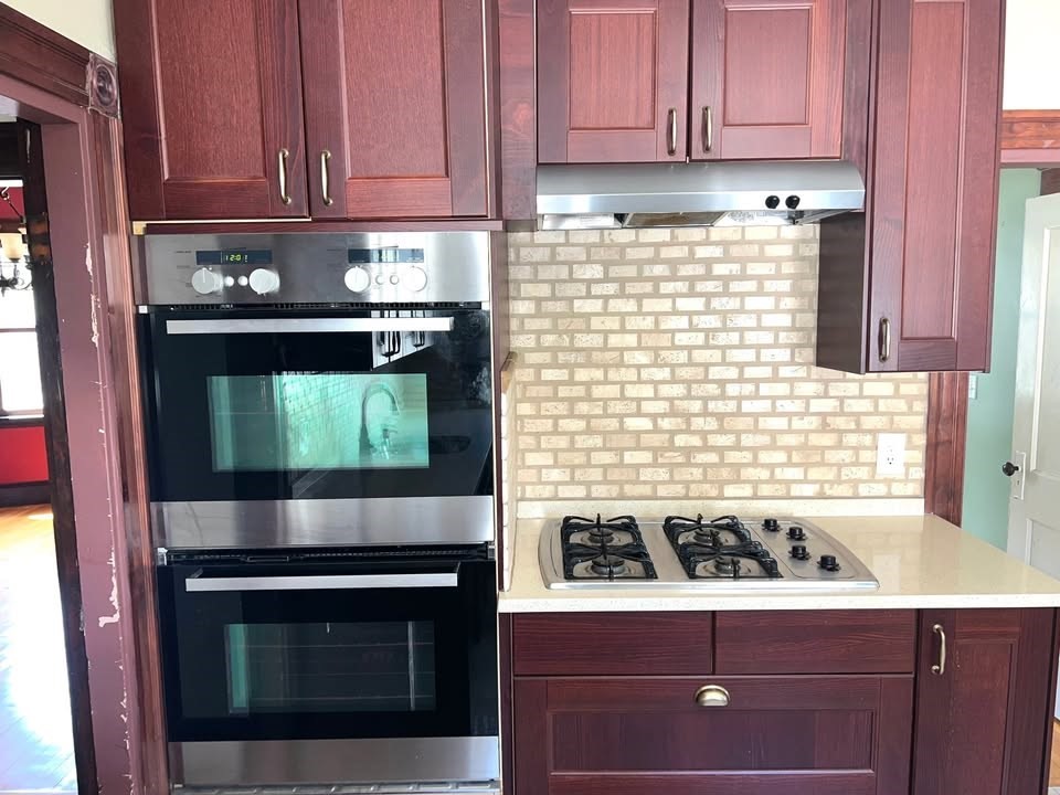29 Richie Road, Unit 2 Quincy, MA 02169 - Photo 6 of 30 a kitchen with granite countertop white cabinets and stainless steel appliances
