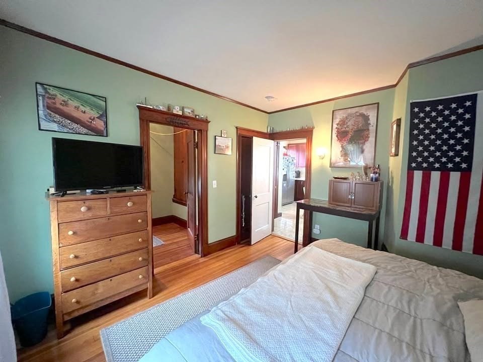 29 Richie Road, Unit 2 Quincy, MA 02169 - Photo 10 of 30 a bedroom with furniture and a flat screen tv