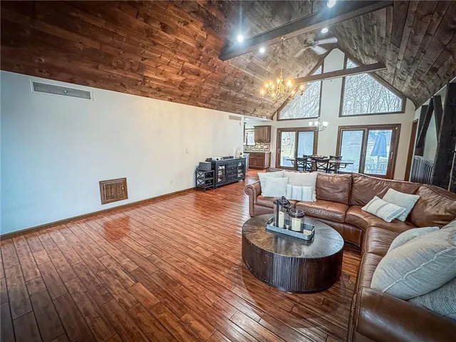 a living room with furniture and a chandelier