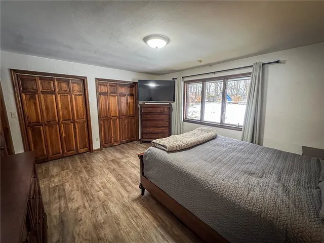 a bedroom with a large bed and a dresser