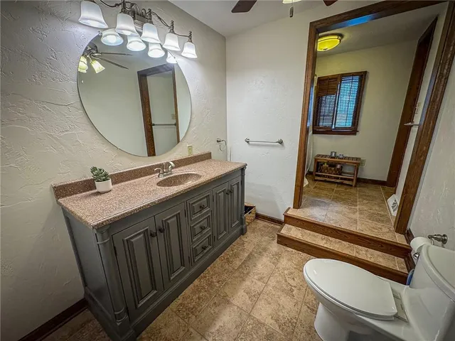 a bathroom with a sink a toilet and a mirror