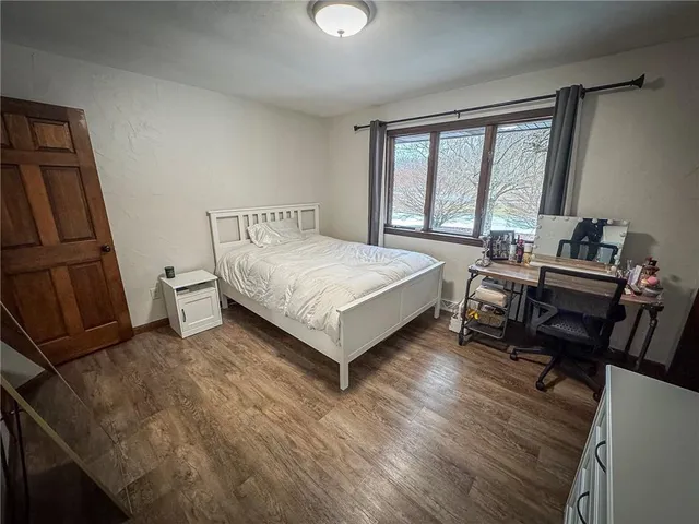 a bedroom with a bed and a large window