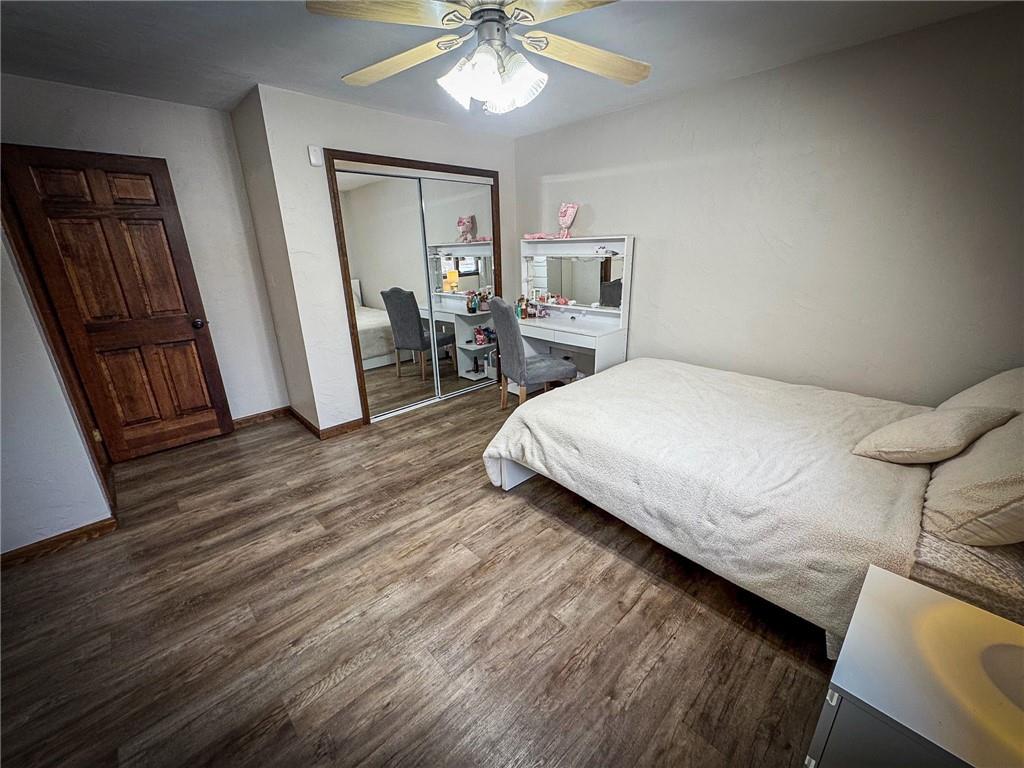 706 Clearfield Road Fenelton, PA 16034 - Photo 31 of 50 a bedroom with a bed a mirror on dresser and a wooden floor