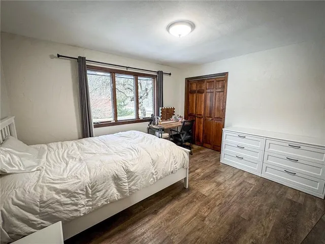 a large bed sitting in a bedroom next to a window