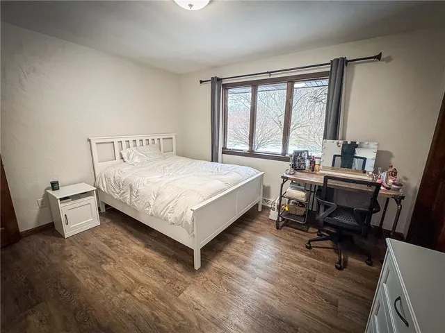 a bed room with a bed and a desk