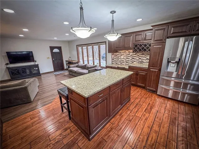a kitchen with a counter space wooden floor and appliances