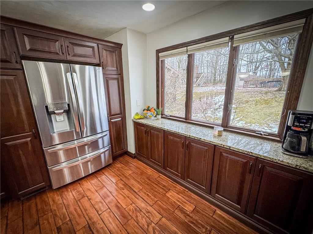 706 Clearfield Road Fenelton, PA 16034 - Photo 6 of 50 a kitchen with stainless steel appliances granite countertop a refrigerator a sink and wooden cabinets