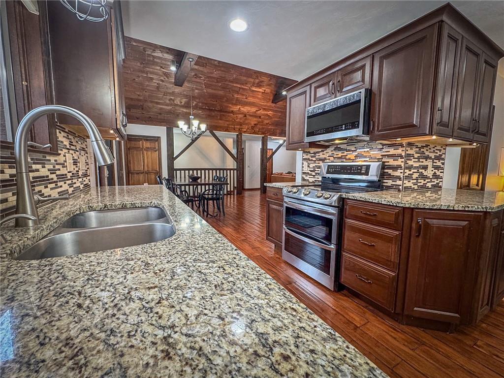 706 Clearfield Road Fenelton, PA 16034 - Photo 7 of 50 a kitchen with stainless steel appliances granite countertop a stove a sink and a microwave