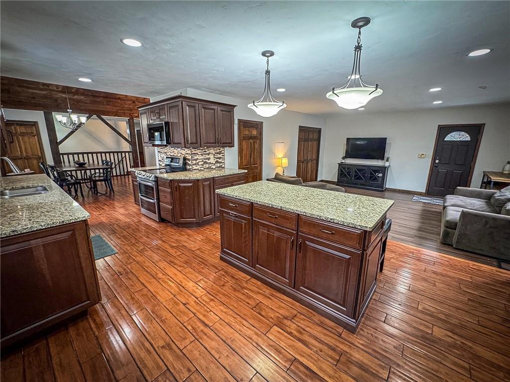 706 Clearfield Road Fenelton, PA 16034 - Photo 9 of 50 a large kitchen with stainless steel appliances wooden floor and a view of living room