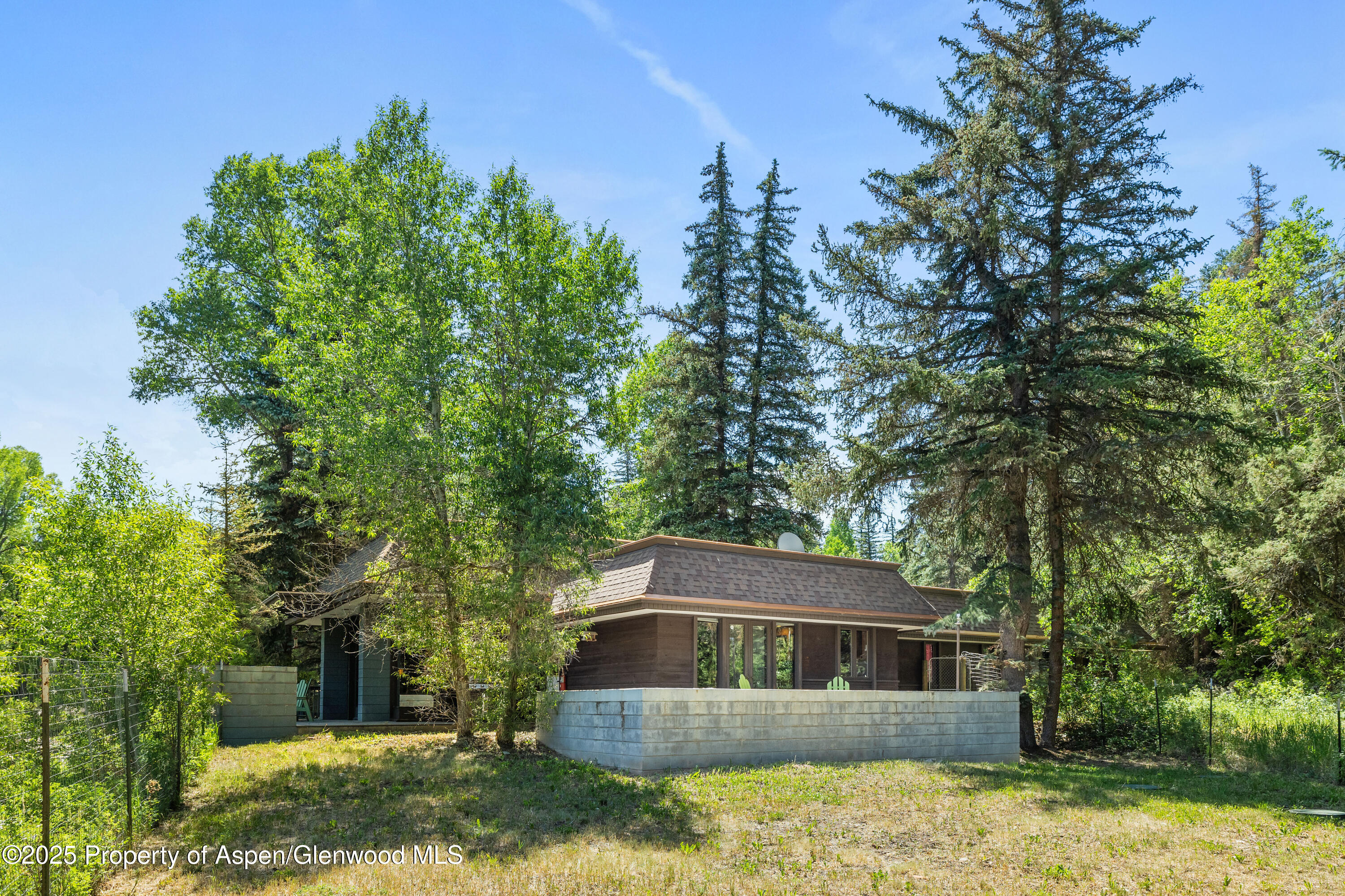 820 Twining Flats Road Aspen, CO 81611 - Photo 13 of 15 a house with trees in the background