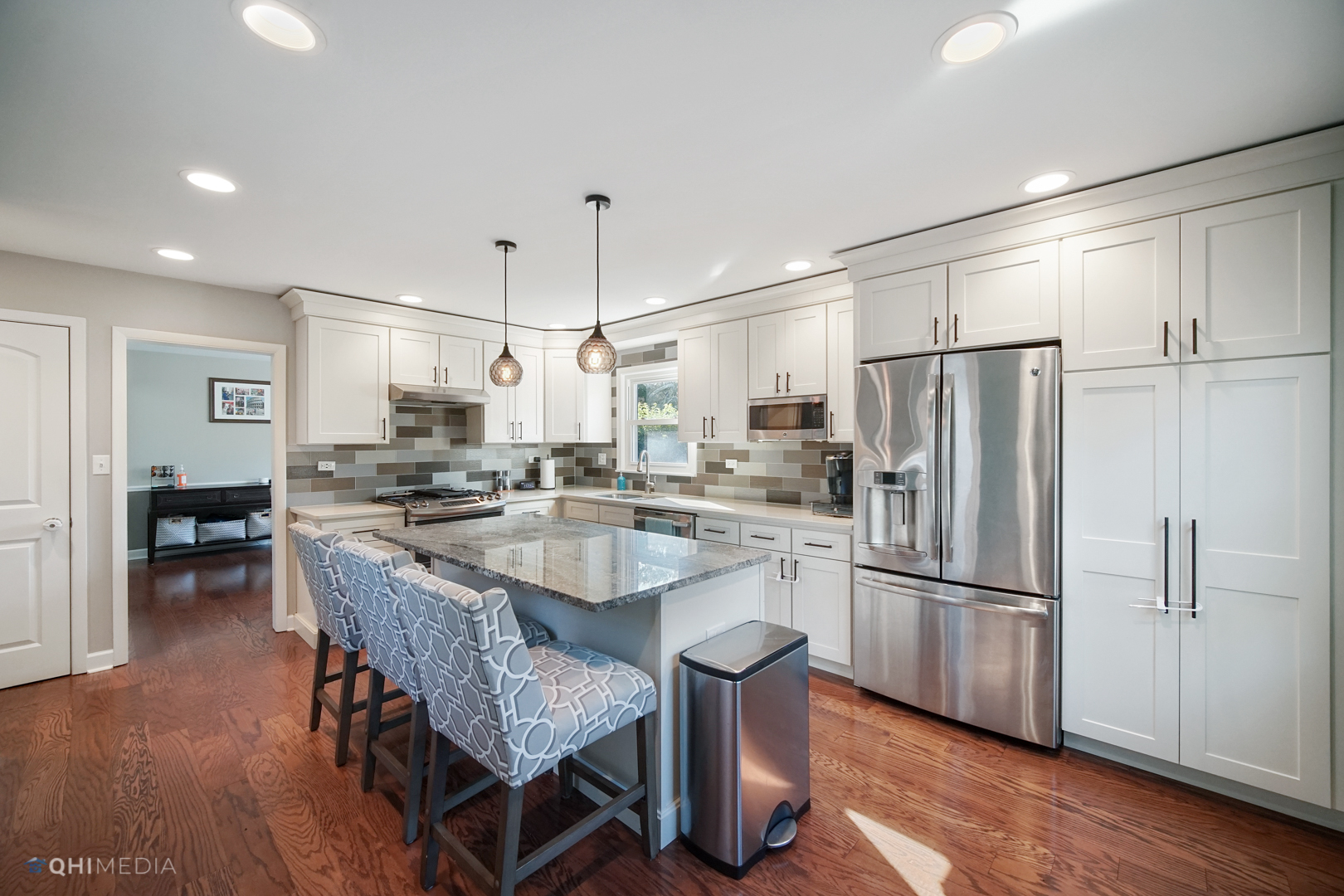 1310 Good Avenue Park Ridge, IL 60068 - Photo 9 of 26 a kitchen with stainless steel appliances granite countertop a refrigerator a sink dishwasher a stove a dining table and chairs with wooden floor
