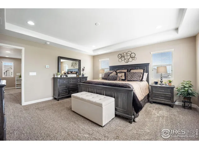 a spacious bedroom with a bed and a couch