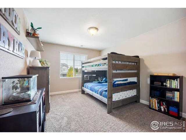 a bedroom with furniture and a book shelf