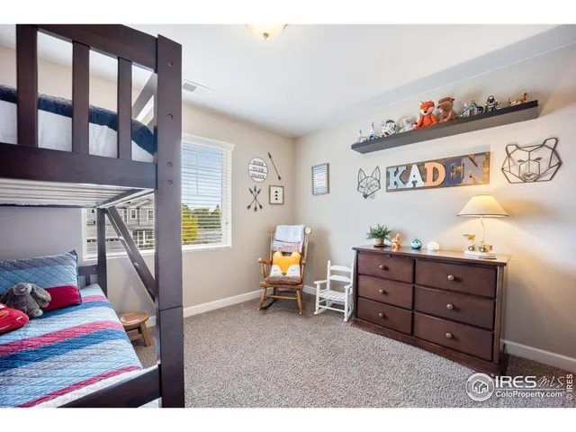 a bedroom with furniture and a book shelf