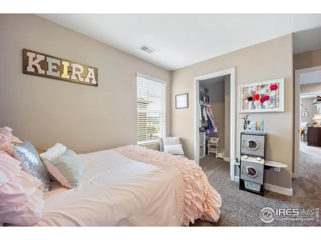 a bedroom with a bed and a desk