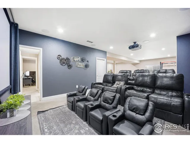 a media room with lots of chairs and flower vase