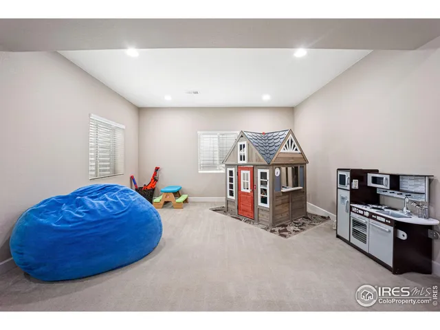 a living room with furniture and a gym equipment