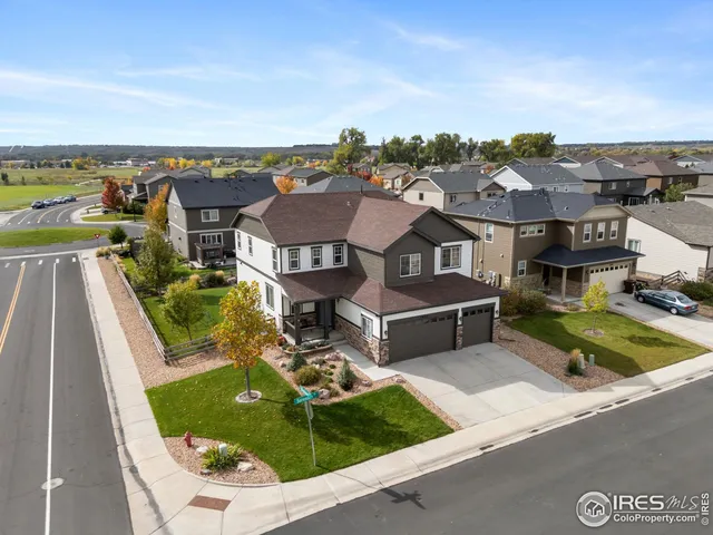 an aerial view of a house with swimming pool and ocean view