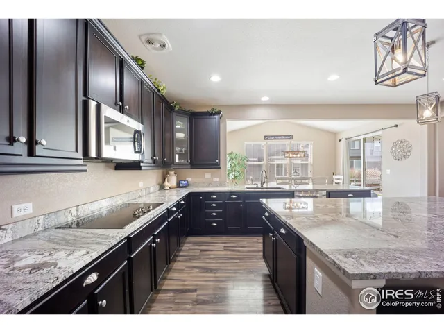 a large kitchen with granite countertop lots of counter space and window