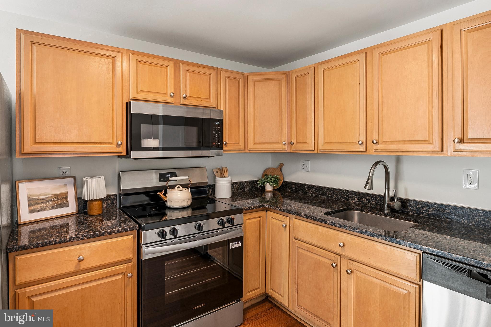 3617 Ripplingbrook Court Bowie, MD 20721 - Photo 3 of 29 a kitchen with granite countertop white cabinets and black appliances