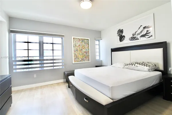 a bedroom with a large bed and a window