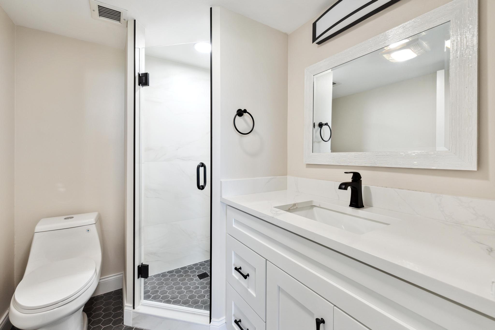 4 Royal Palm Way, Unit 2080 Boca Raton, FL 33432 - Photo 14 of 23 a bathroom with a sink a toilet and shower