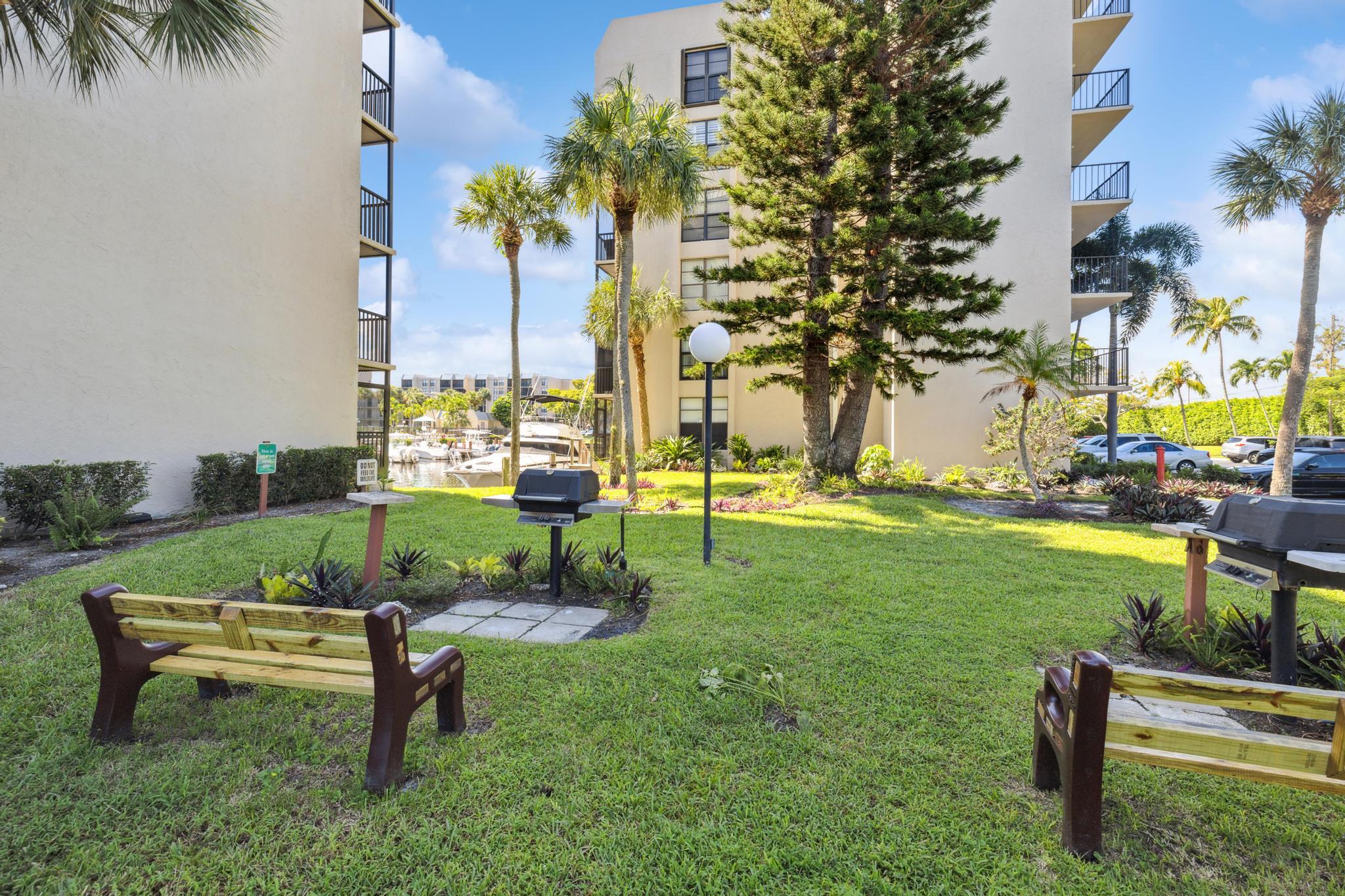 4 Royal Palm Way, Unit 2080 Boca Raton, FL 33432 - Photo 17 of 23 a park bench sitting in the middle of a park