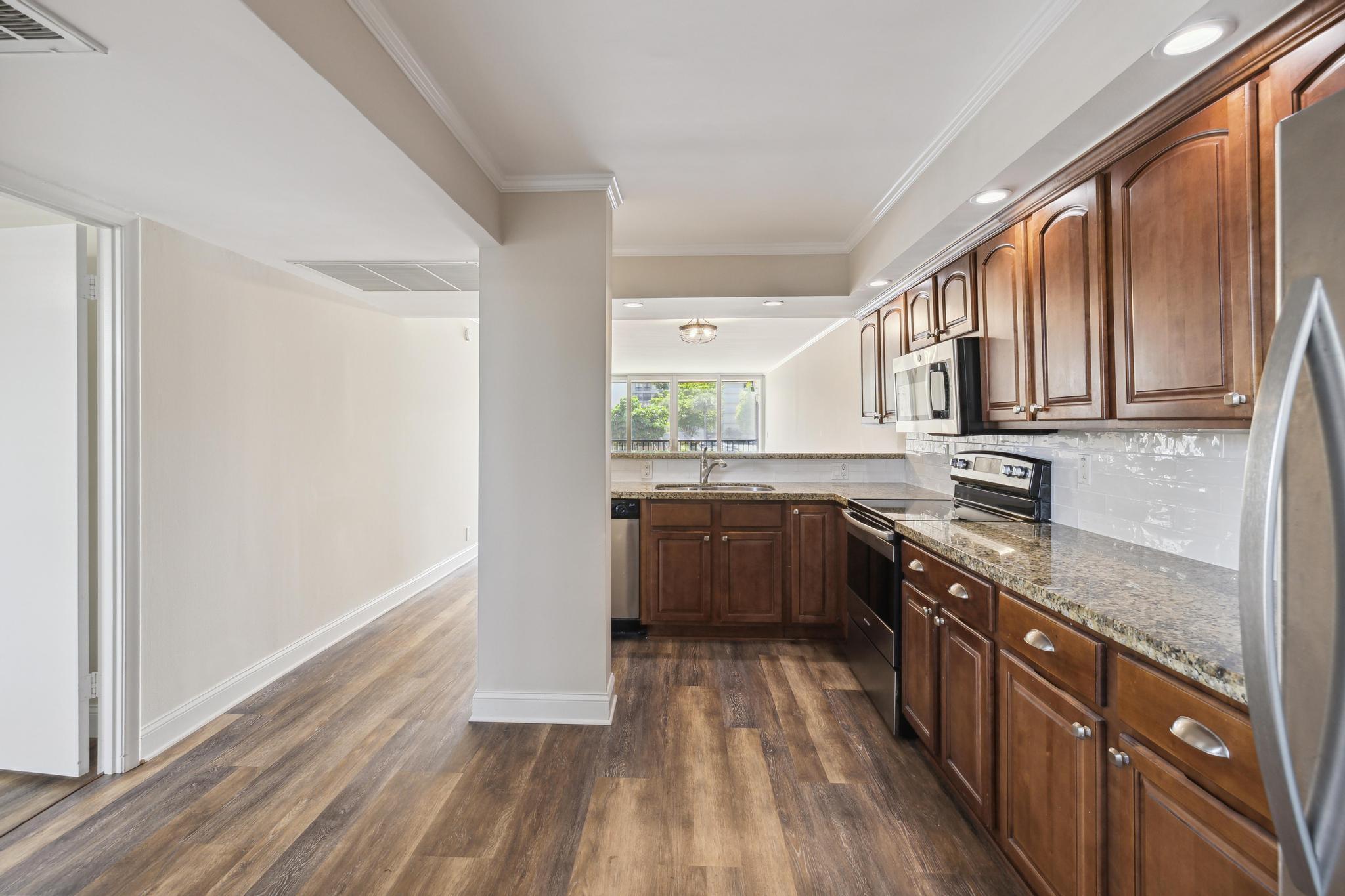 4 Royal Palm Way, Unit 2080 Boca Raton, FL 33432 - Photo 4 of 23 a kitchen with stainless steel appliances granite countertop a stove a sink and a refrigerator
