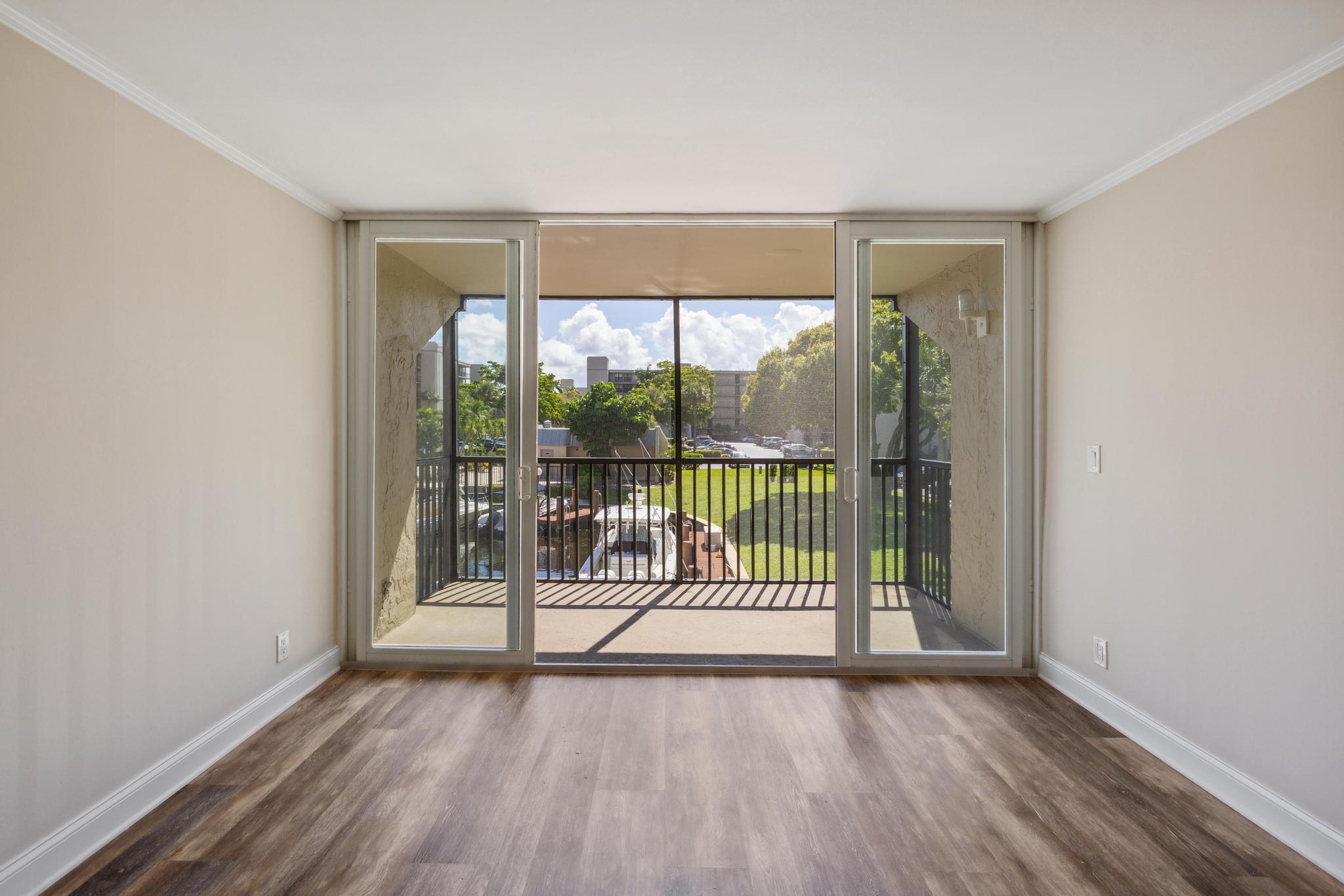 4 Royal Palm Way, Unit 2080 Boca Raton, FL 33432 - Photo 6 of 23 an empty room with wooden floor and windows