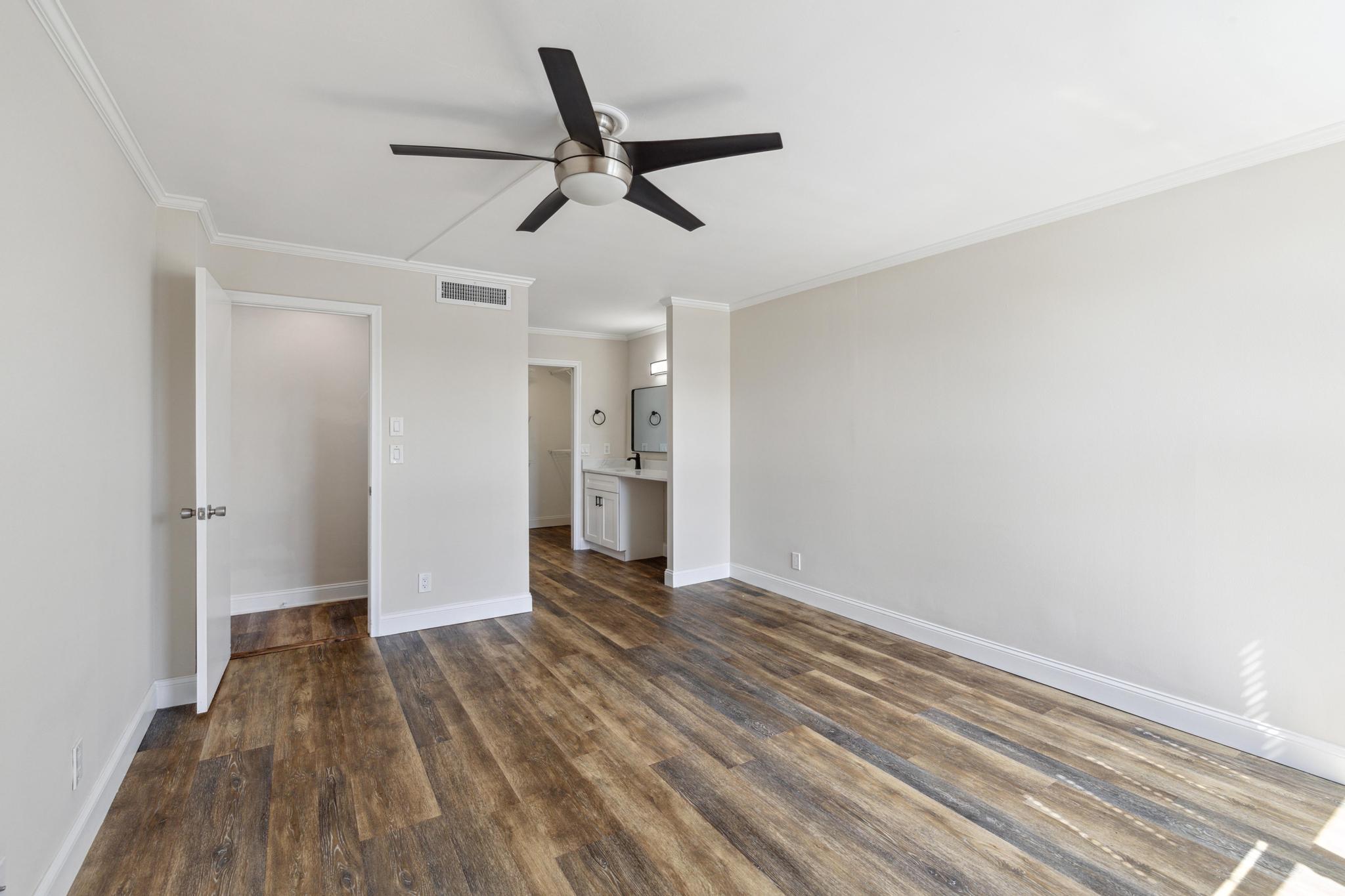 4 Royal Palm Way, Unit 2080 Boca Raton, FL 33432 - Photo 9 of 23 a view of a livingroom with wooden floor and a ceiling fan