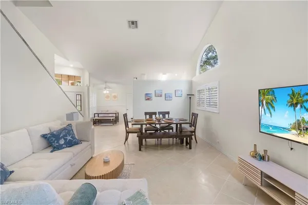 a living room with furniture and a painting on the wall